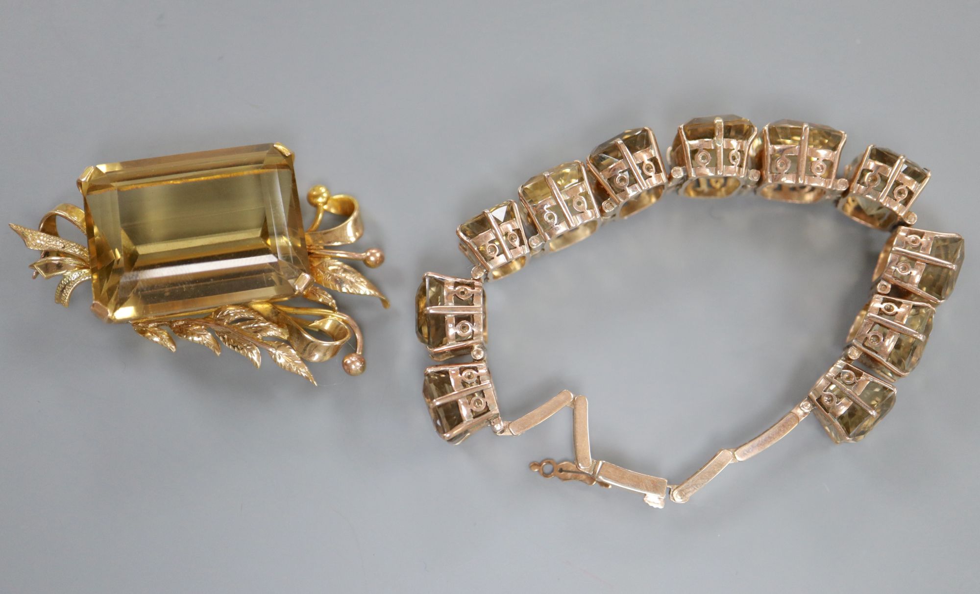 A modern yellow metal and citrine set foliate brooch, 49mm, gross 25 grams and a similar bracelet